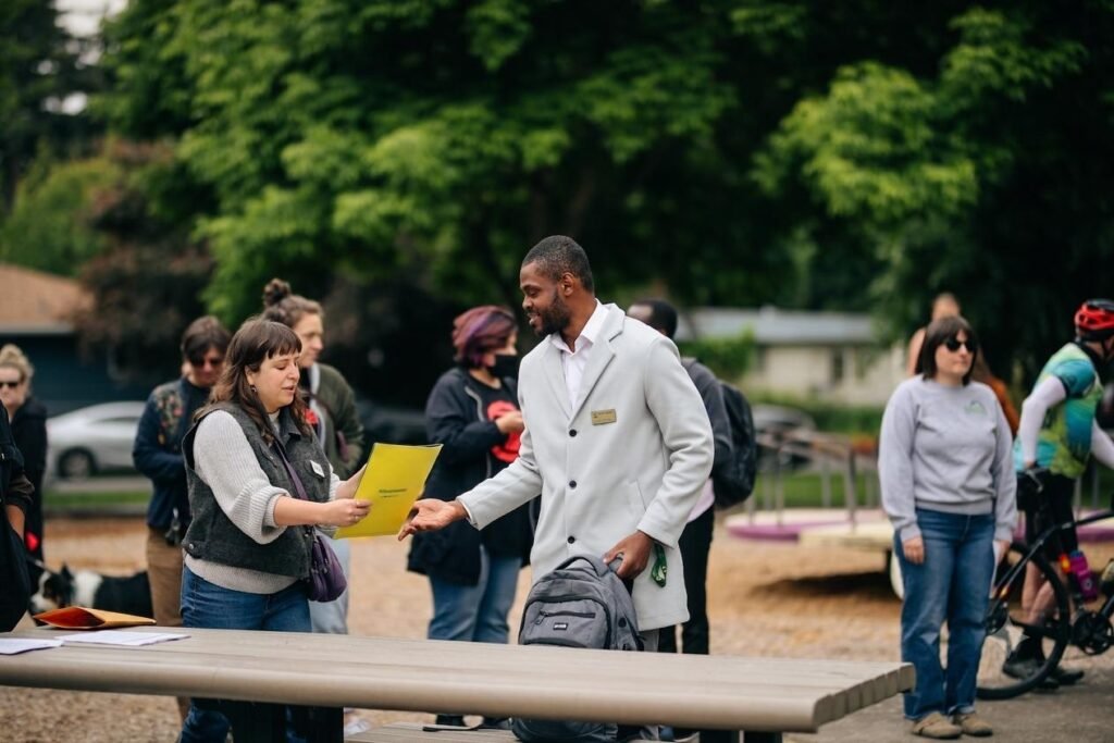 Daniel Appiah Gyekye talking with community members at a Eugene street safety event