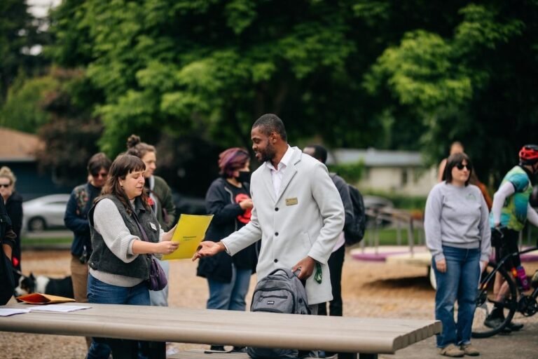 Daniel Appiah Gyekye talking with community members at a Eugene street safety event